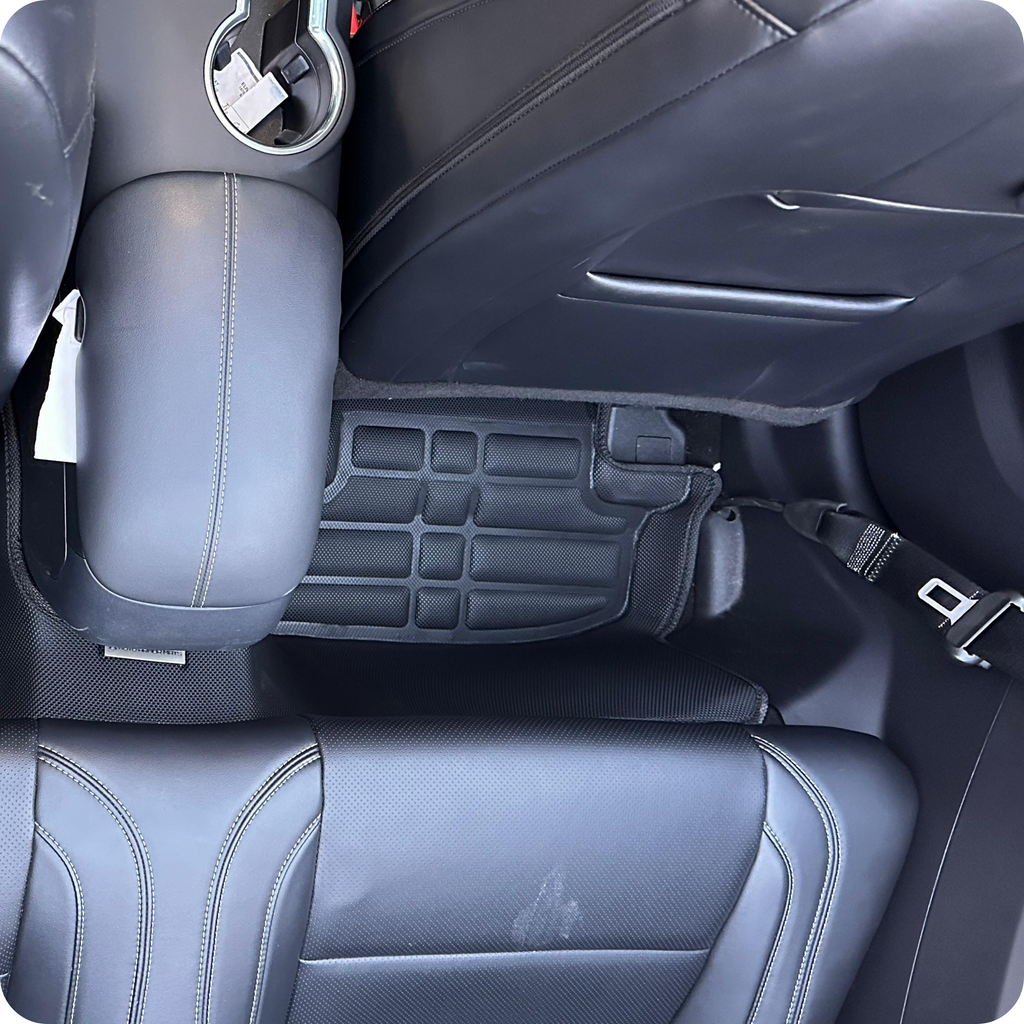 Car interior with gray leather seats and a seat mat.